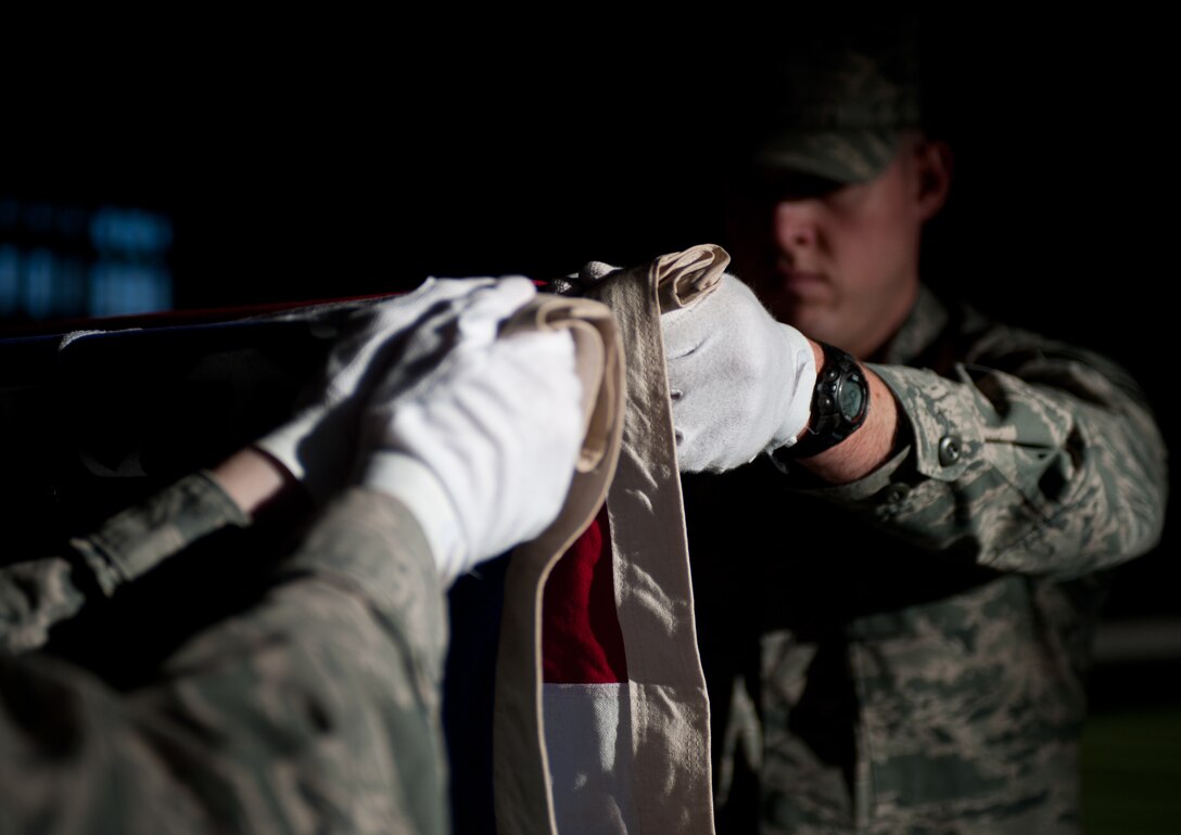 Senior Airman Daniel Pohorelsky, 28th Force Support Squadron base Honor Guard member, prepares to fold a U.S. flag during a training exercise at Ellsworth Air Force Base, S.D., Dec. 12, 2012. Once the flag is properly folded, the leader of the detail presents the flag to the next of kin as a way of thanking the servicemember and their family for their service to the country. (U.S. Air Force photo by Airman 1st Class Alystria Maurer/Released)