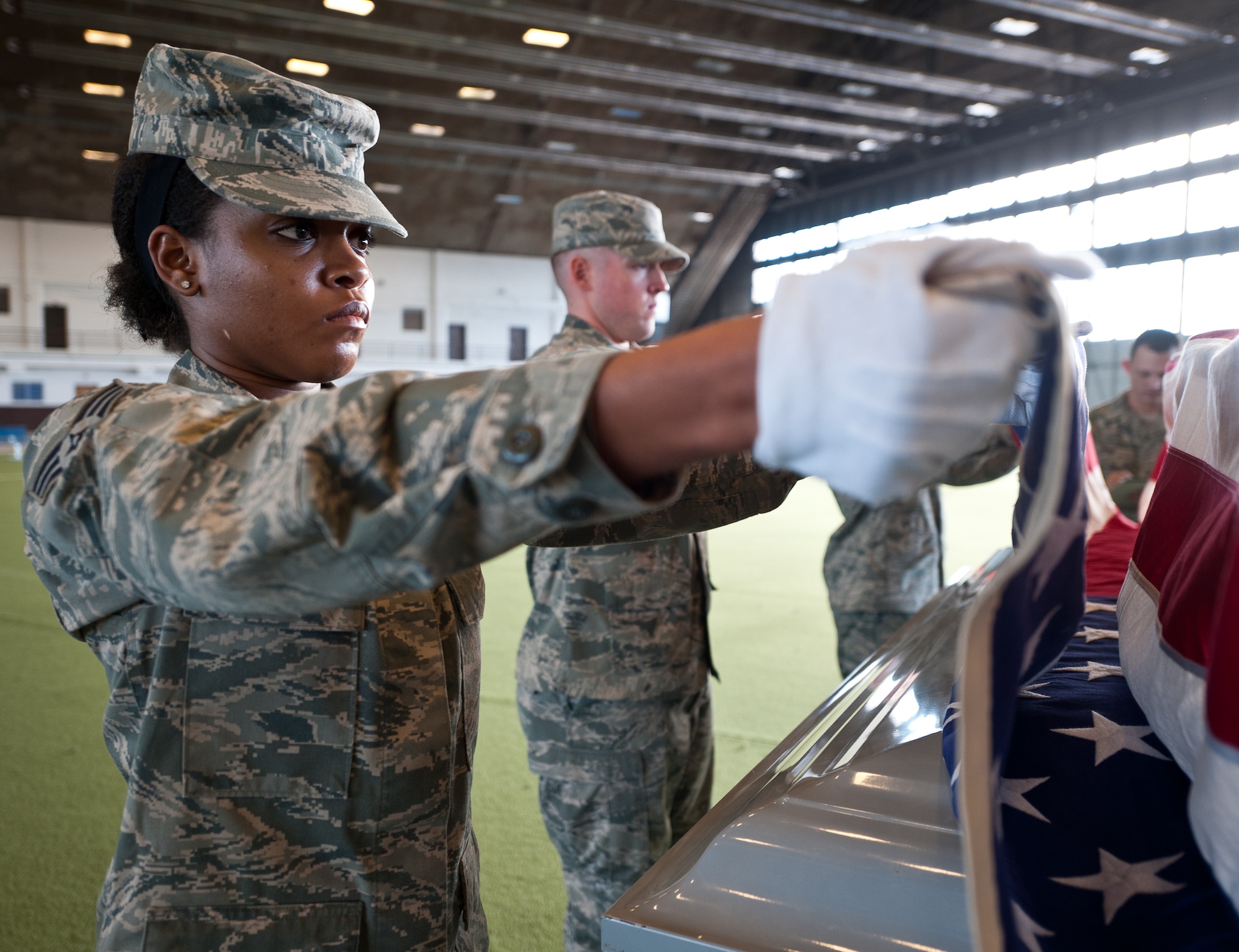 Senior Airman Medferiash Gordon, 28th Force Support Squadron base Honor Guard members, prepares to fold a U.S. flag during training at Ellsworth Air Force Base, S.D., Dec. 12, 2012. The base Honor Guard pays tribute to those who have served by performing a variety of military honors for active-duty servicemembers and U.S. military retirees. (U.S. Air Force photo by Airman 1st Class Alystria Maurer/Released)