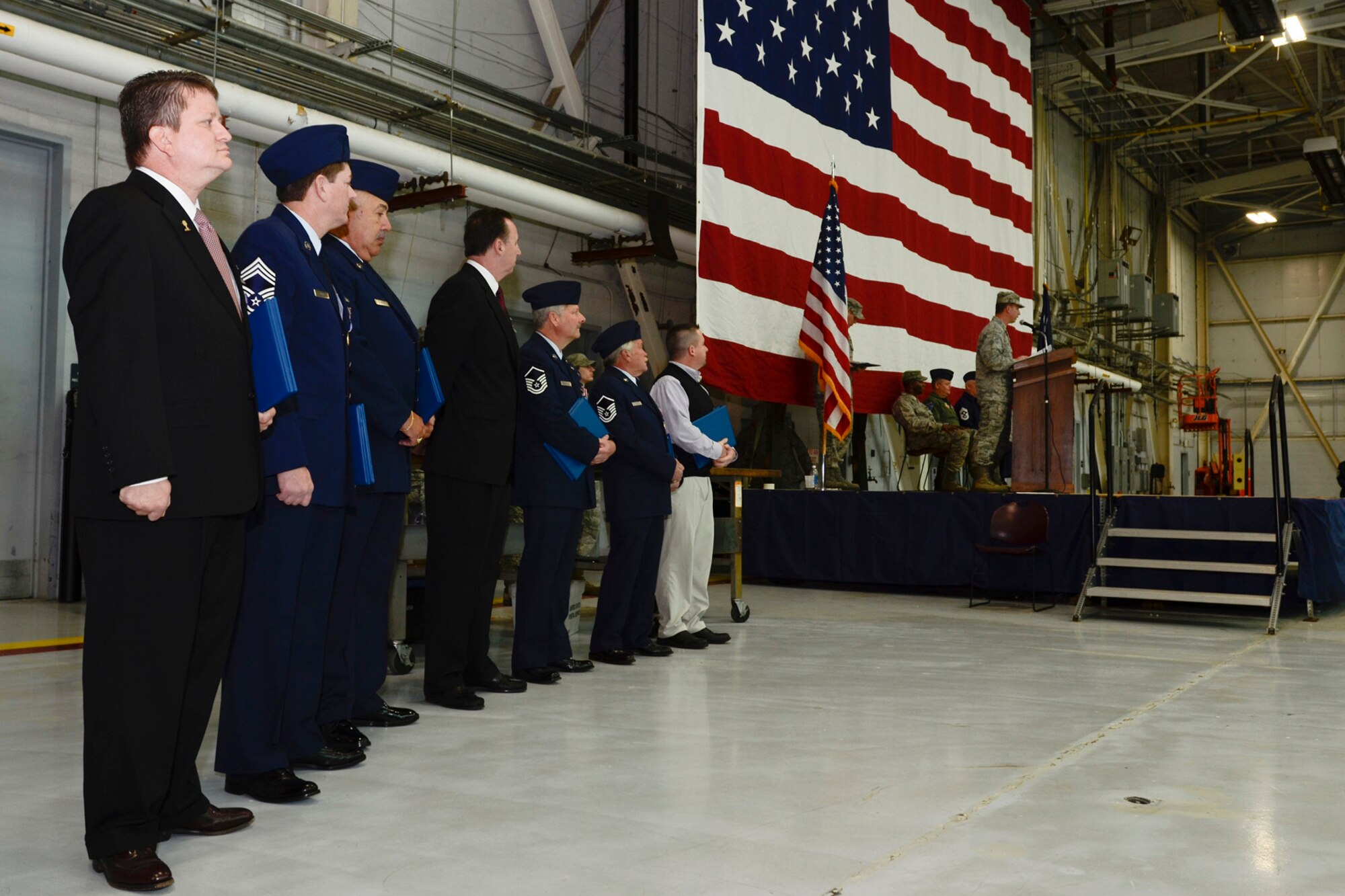 Col. Mike Hudson, Commander of the 169th Fighter Wing at McEntire Joint National Guard Base, S.C., presents recent SCANG retirees with the Meritorious Service Medal and the Guardsman Retirement Medal during a mass formation Dec. 9, 2012. A change of command was also performed as Mr. Steven Mungo, the owner of Mungo Homes, assumed the 169th FW Honorary Commander position from Mr. Bill Dukes, the owner of the Columbia restaurant Blue Marlin.  (National Guard photo by Staff Sgt Jorge Intriago/Released)