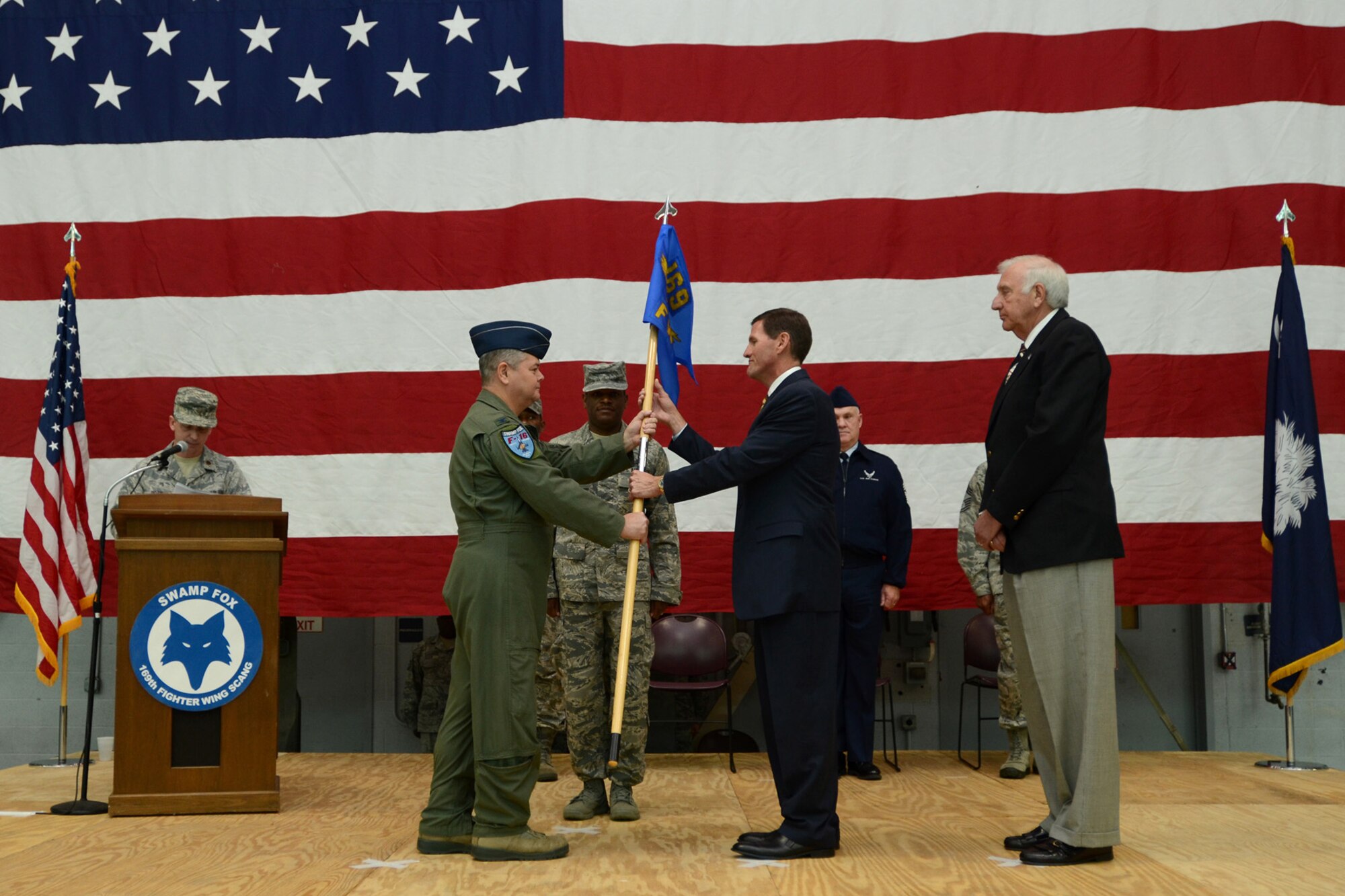Col. Mike Hudson, Commander of the 169th Fighter Wing at McEntire Joint National Guard Base, S.C., presents recent SCANG retirees with the Meritorious Service Medal and the Guardsman Retirement Medal during a mass formation Dec. 9, 2012. A change of command was also performed as Mr. Steven Mungo, the owner of Mungo Homes, assumed the 169th FW Honorary Commander position from Mr. Bill Dukes, the owner of the Columbia restaurant Blue Marlin.
(National Guard photo by Tech. Sgt. Caycee Watson/Released)
