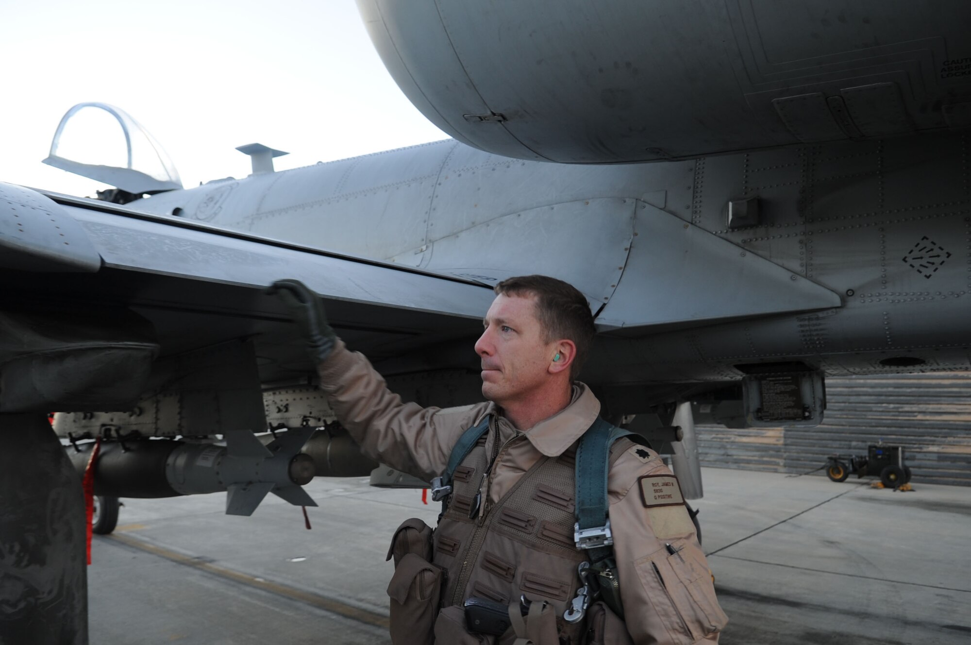 BAGRAM AIRFIELD, Afghanistan - Lt. Col. James 'Kil' Roy, 455th Expeditionary Operations Squadron director of operations, performs a pre-flight inspection on his A-10 Thunderbolt II, Dec. 19, 2012. Roy recently achieved 1,000 combat hours, all in the A-10 flying missions in Afghanistan. (U.S. Air Force Photo/Staff Sgt. David Dobrydney)