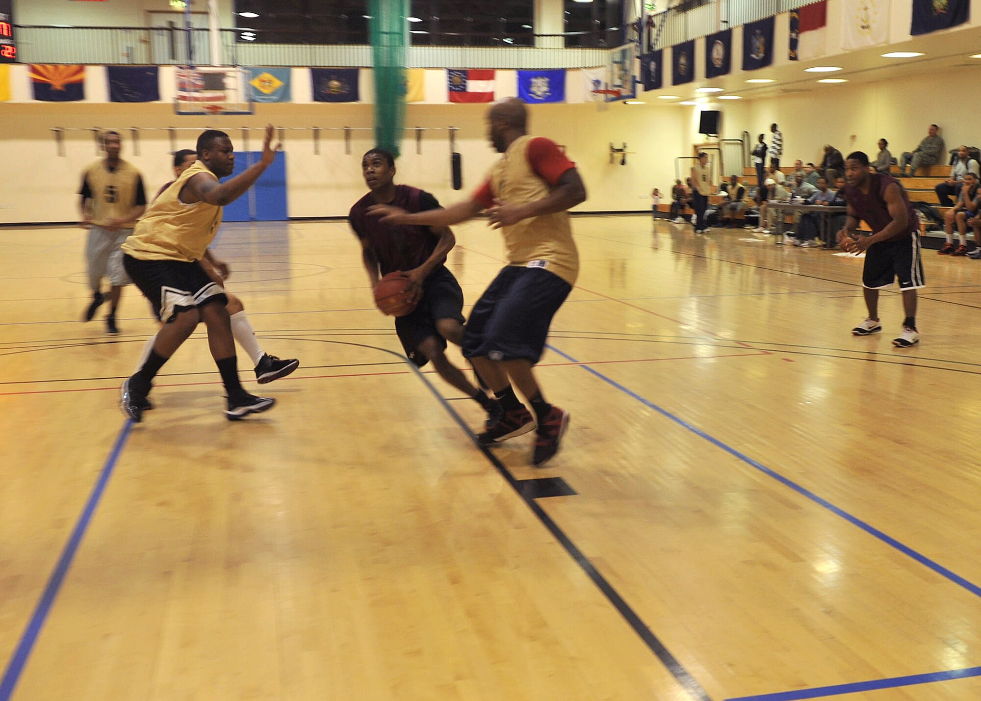 Airman 1st Class Michael Clarke, 100th Security Forces Squadron patrolman from Miami, makes his way to the basket during an intramural basketball game Dec. 18, 2012, at the Hardstand Fitness Center at RAF Mildenhall, England. This was the first game of the season. (U.S. Air Force photo by Senior Airman Jerilyn Quintanilla/Released)