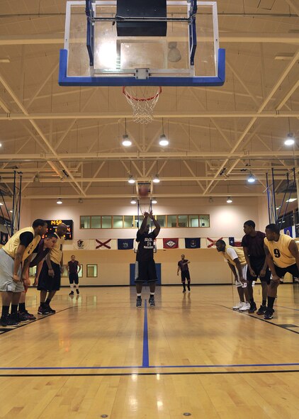 Staff Sgt. Jonathan Preston, 100th Security Forces Squadron patrolman from Columbia, S.C., takes a shot from the free-throw line during an intramural basketball game against the 100th Communications Squadron Dec. 18, 2012, at the Hardstand Fitness Center at RAF Mildenhall, England. This was the first game of the season. (U.S. Air Force photo by Senior Airman Jerilyn Quintanilla/Released)