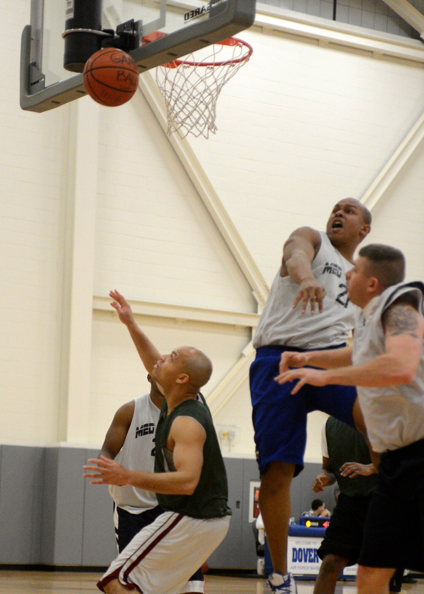 Ray Pitt, 436th Medical Group forward, rejects a shot by 436th Force Support Squadron player-coach Antwan Piper during an intramural basketball game Dec. 17, 2012, at the fitness center on Dover Air Force Base, Del. The 436th MDG edged by the 436th FSS 42-41. (U.S. Air Force photo by Tech. Sgt. Chuck Walker)