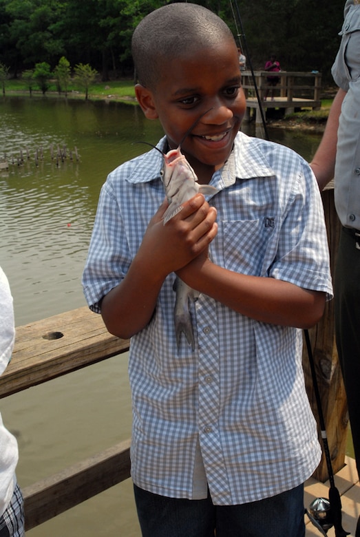 Children crowded and smiled as they witnessed one of their peers catch a fish. For many of these children, this was the first time they have had the opportunity to go fishing. (USACE photo by Michael Rivera)