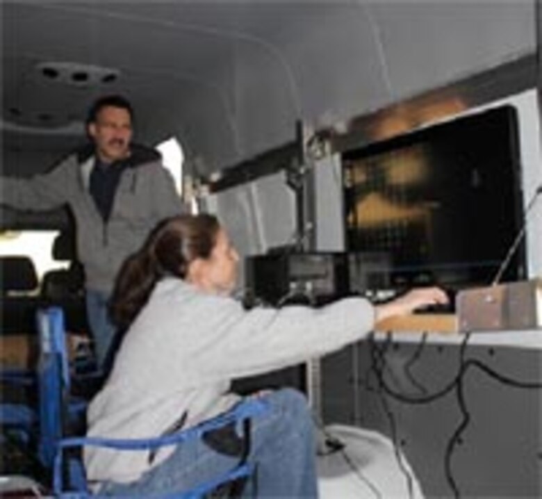 ERDC-TEC Researchers Drs. Jean Nelson and John Anderson review data on the computers inside the lab's workspace.