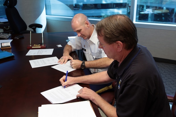 During an informal signing ceremony, Jacksonville District Commander Col. Alan Dodd added his name to a cooperative agreement along with U.S. Fish and Wildlife Service (USFWS) Florida field office supervisors to help manatees and insure the Corps' navigation mission moves forward.