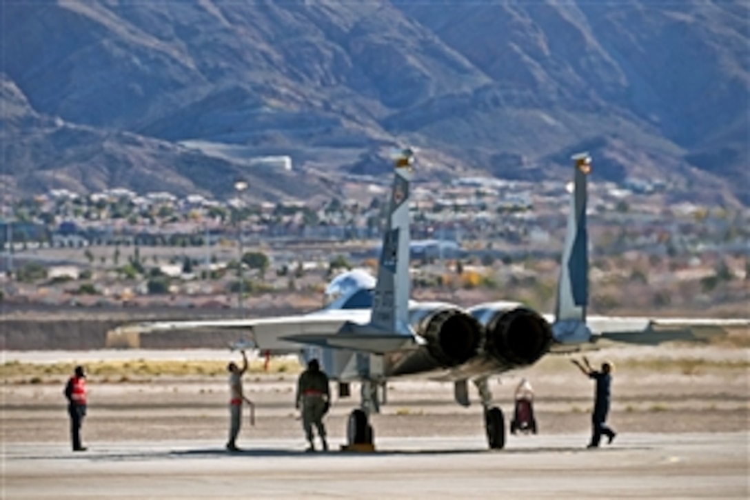 Air Force crew chiefs conduct pre-flight checks during a mission employment phase exercise on Nellis Air Force Base, Nev., Dec. 7, 2012. The crew chiefs are assigned to the 757th Aircraft Maintenance Squadron. The phase is the capstone, graduation exercise conducted by the U.S. Air Force Weapons School.