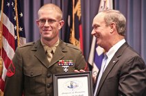 Cpl. Joshua T. Shakeshaft, a combat engineer and head instructor for improvised explosive device awareness at the Battle Skills Training School aboard Camp Lejeune, N.C., accepts the 2012 Veteran of the Year award from Mayor Sammy Phillips of Jacksonville, N.C., during a ceremony held Nov. 20, 2012. Shakeshaft received the award for his ongoing efforts to help wounded veterans. (Photo by Lisa Miller, media specialist, City of Jacksonville, N.C.) 
