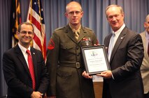 Cpl. Joshua T. Shakeshaft, a combat engineer and head instructor for improvised explosive device awareness at the Battle Skills Training School aboard Camp Lejeune, N.C., accepts the 2012 Veteran of the Year award from Mayor Sammy Phillips (right) of Jacksonville, N.C., during a ceremony held Nov. 20, 2012. The ceremony recognized 30 veterans from around the area for outstanding service to the community. 