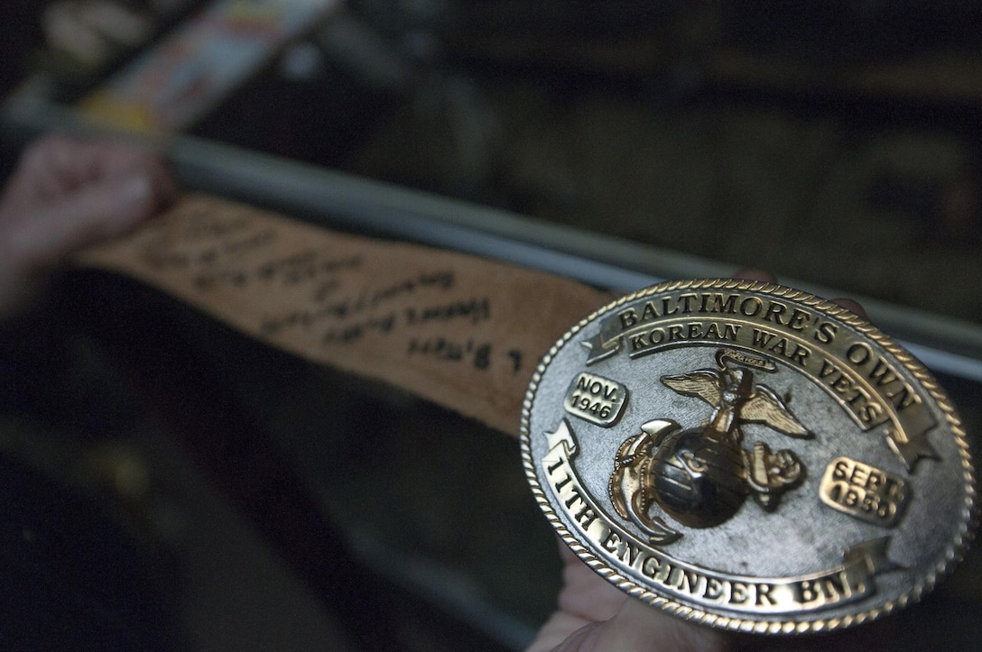 BALTIMORE—Donald Rollette, a retired Reserve Marine, displays his Marine Corps League Baltimore Detachment belt buckle in the basement of his house in Baltimore, Oct. 16, 2012. The names of 15 friends who perished in Korea in 1950 are written on the belt. Rollette collects military items in order uphold their honor. (U.S. Marine Corps photo by Cpl. Marcin Platek/Released)