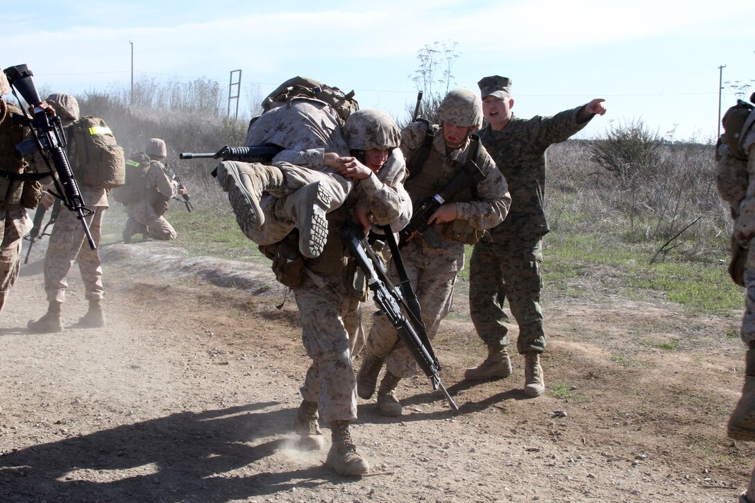 Recruits of Company I, 3rd Recruit Training Battalion, evacute their wounded after they were hit with a simulated improvise explosive devices on the IED lane during the Crucible at Edson Range aboard Marine Corps Base Camp Pendleton, Calif. Dec. 11. The IED lane teaches recruits to be aware and alert during patrols.