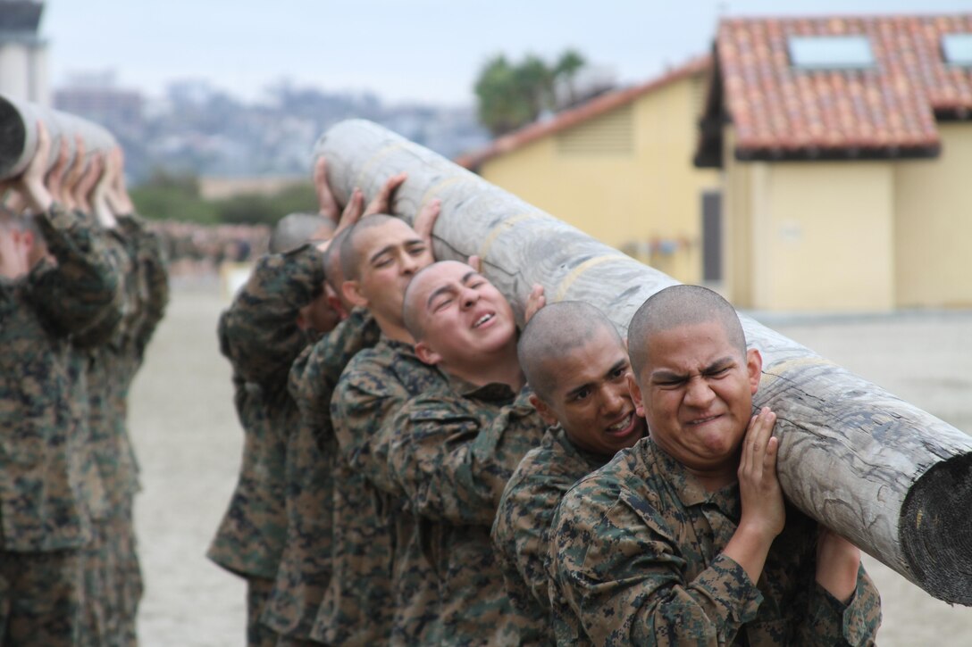 Recruits struggle to lift the front end of the log during log drills aboard Marine Corps Recruit Depot San Diego Dec. 18. Recruits learned how to work together as a team and that if one recruit didn't carry their weight the rest of the group would suffer.