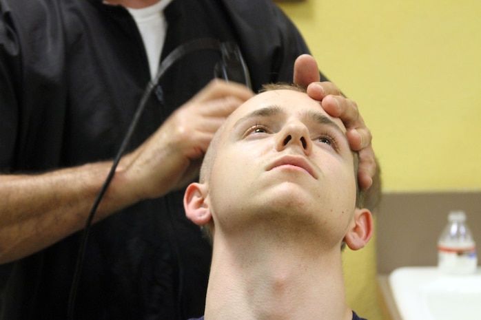 A new recruit receives his first Marine haircut during the receiving process aboard Marine Corps Recruit Depot San Diego Dec. 17.  Each recruit is shaved bald to establish uniformity and let recruits know they are no longer individuals.