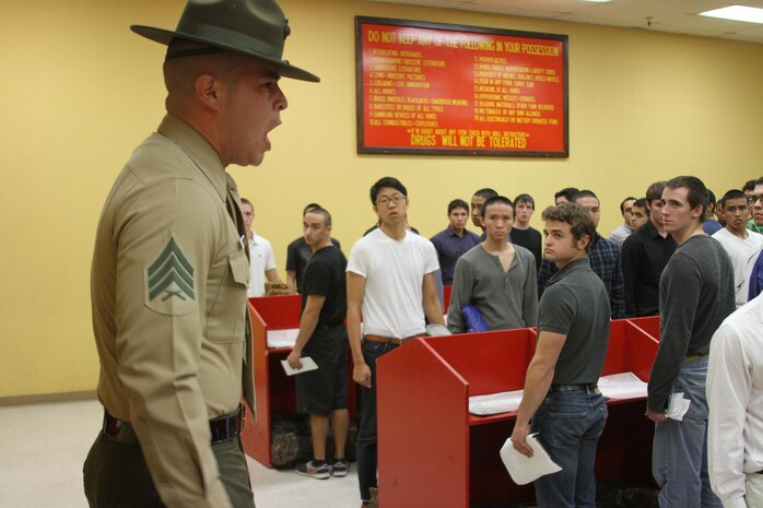 A drill instructor with Receiving Company, Recruit Training Regiment, instructs recruits to empty their pockets of their personal belongings in the contraband room during the receiving process aboard Marine Corps Recruit Depot San Diego Dec. 17. Each recruit gets rid of the items they won't need during training.