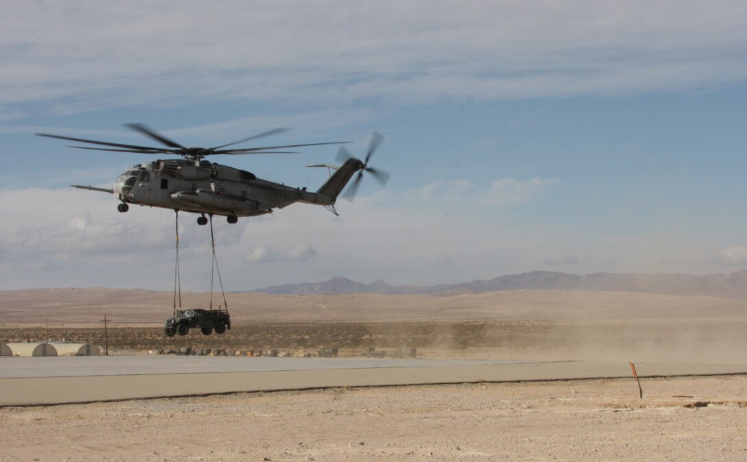 A CH-53E Super Stallion with Marine Heavy Helicopter Squadron 465 sets down a Humvee  during the Steel Knight exercise aboard Marine Corps Air Ground Combat Center, Twentynine Palms, Calif., Dec. 14. During the exercise, three Super Stallions with HMH-465 lifted and transported many supplies as well as two Humvees back to Camp Wilson aboard MCAGCC Twentynine Palms.  

