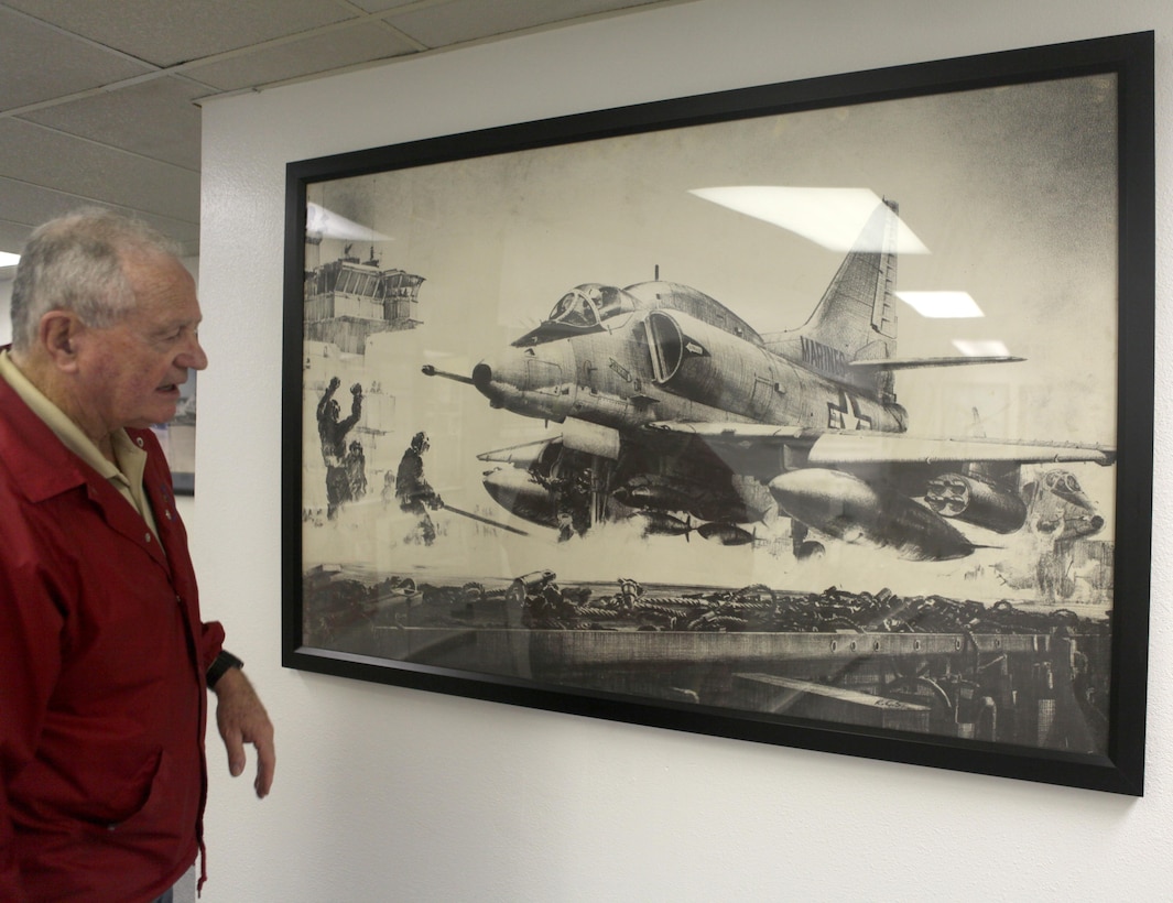 Retired Lt. Col. Jay N. Bibler, a former F-4 Phantom pilot, and a San Jaquin Valley, Calif., native, shows an artistâ€™s drawing of an A-4 in the Flying Leatherneck Aviation Museum, Dec. 18. Bibler flew the A-4 aboard Marine Corps Air Station El Toro, Calif., in the 1960â€™s before he transitioned to flying the F-4 Phantom.
