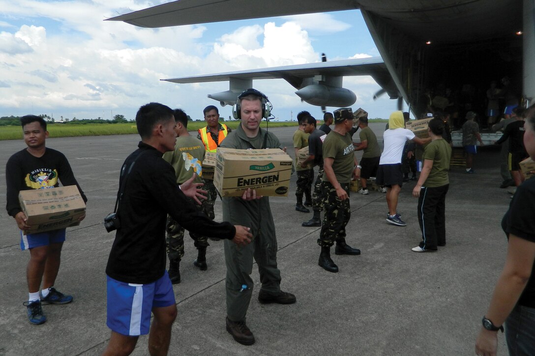 Philippine service members and U.S. Marines off-load relief supplies from a U.S. Marine Corps KC-130J Hercules aircraft Dec. 15 at Davao International Airport, Mindanao, Republic of the Philippines. Marines supported Philippine-led relief efforts in the wake of Typhoon Bopha, demonstrating the importance of forward-deployed Marine forces in the Asia-Pacific region. 
