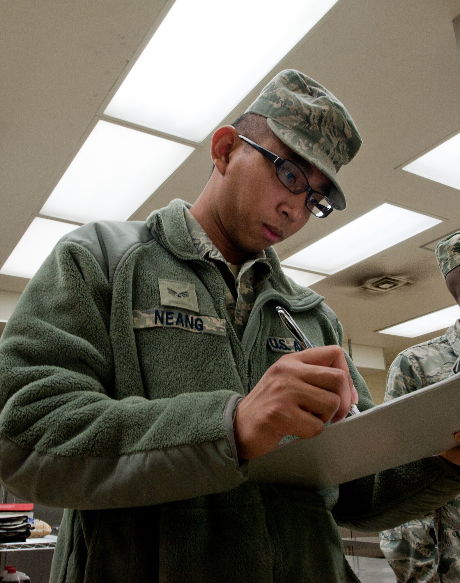 YOKOTA AIR BASE, Japan -- Senior Airman Perry Neang, 374th Civil Engineer Squadron Pest Management technician, fills out inspection paperwork Dec. 19, 2012, at Yokota Air Base, Japan. The pest management team performs monthly inspections at base facilities to ensure insect-free work and home areas. (U.S. Air Force photo by Airman 1st Class John D. Partlow)