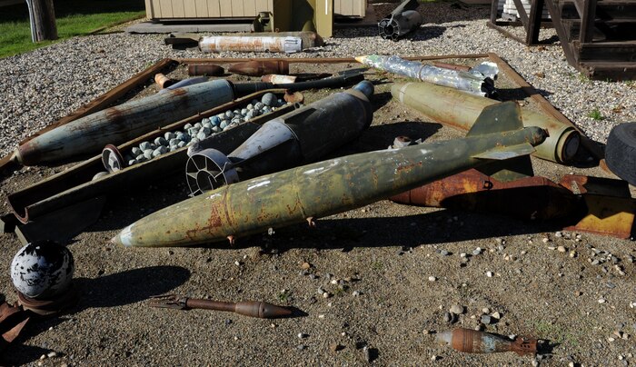 Inert ordnance is purposefully placed in a pit outside the Explosive Ordinance Disposal Flight at Beale Air Force Base, Calif., Dec. 19, 2012. The training aids are exposed to weather elements to simulate what EOD technicians might encounter in the field. (U.S. Air Force photo by Staff Sgt. Robert M. Trujillo/Released) 