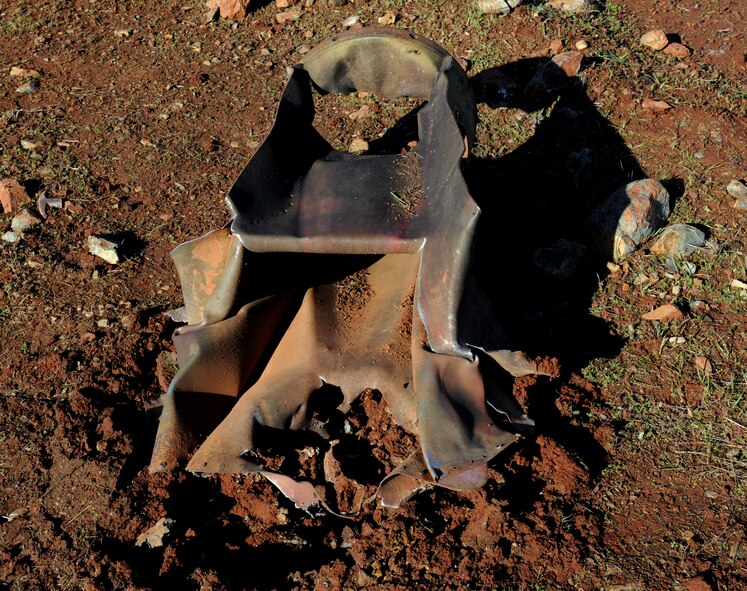 Inert ordnance is damaged by a shaped charge at the explosive ordinance disposal range on Beale Air Force Base, Calif., Dec. 19, 2012. EOD Airmen often train with different explosives to see the blasting effects. (U.S. Air Force photo by Staff Sgt. Robert M. Trujillo/Released)