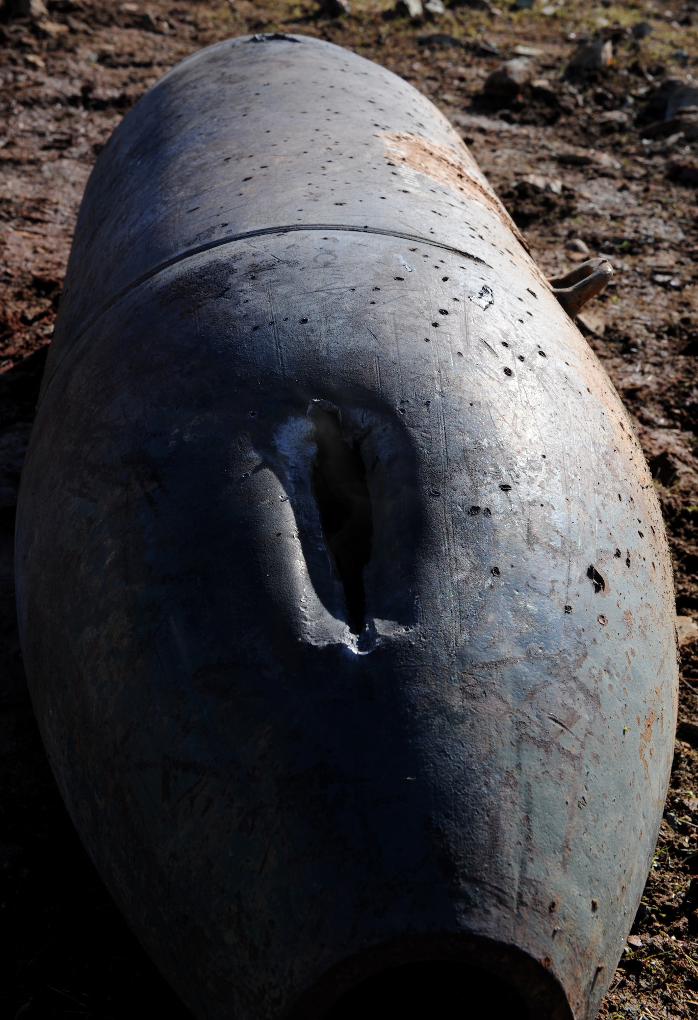 Inert ordnance is damaged by a shaped charge at the explosive ordinance disposal range on Beale Air Force Base, Calif., Dec. 19, 2012. EOD Airmen often train with different explosives to see the blasting effects. (U.S. Air Force photo by Staff Sgt. Robert M. Trujillo/Released)