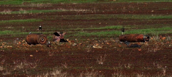 Shaped charge explosives are placed on training aid bombs at the explosive ordinance disposal range on Beale Air Force Base, Calif., Dec. 19, 2012. EOD Airmen train with different types of explosives to simulate what they may encounter in the field. (U.S. Air Force photo by Staff Sgt. Robert M. Trujillo/Released)