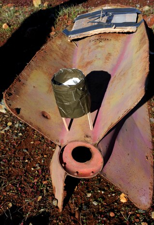 Shaped charge explosives are placed on training aid bombs at the explosive ordinance disposal range on Beale Air Force Base, Calif., Dec. 19, 2012. EOD Airmen train with different types of explosives to simulate what they may encounter in the field. (U.S. Air Force photo by Staff Sgt. Robert M. Trujillo/Released)