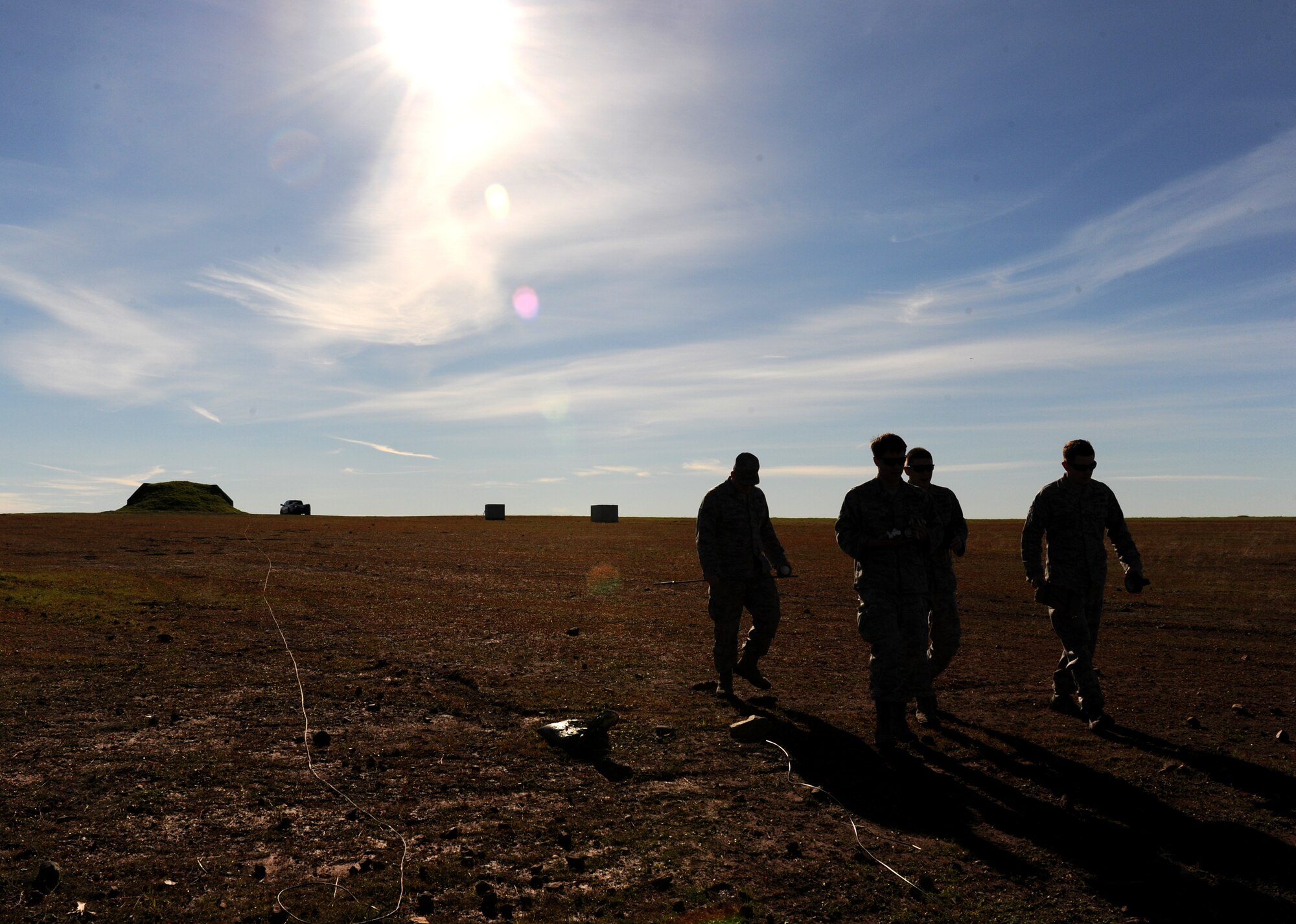 Members of the 9th Civil Engineer Squadron Explosive Ordnance Disposal Flight walk the EOD range during a training scenario at Beale Air Force Base, Calif., Dec. 19, 2012. EOD Airmen train with different types of explosives to simulate what they may encounter in the field. (U.S. Air Force photo by Staff Sgt. Robert M. Trujillo/Released)