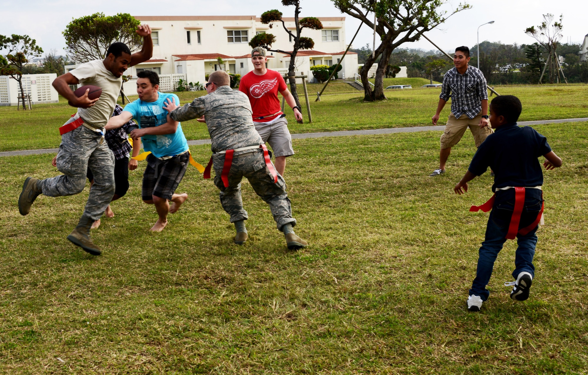 Members from the 353rd Special Operations Group and family members enjoy a game of football during the 353rd SOG Wingman Day picnic.  The Wingman Day picnic was just one of many events held by the 353rd SOG to take time away from the day-to-day mission and bring together the entire group to include family members.  Earlier in the day, workcenters held small group discussions while the chaplain held a forum with family members.  (U.S. Air Force photo/Tech. Sgt. Kristine Dreyer)