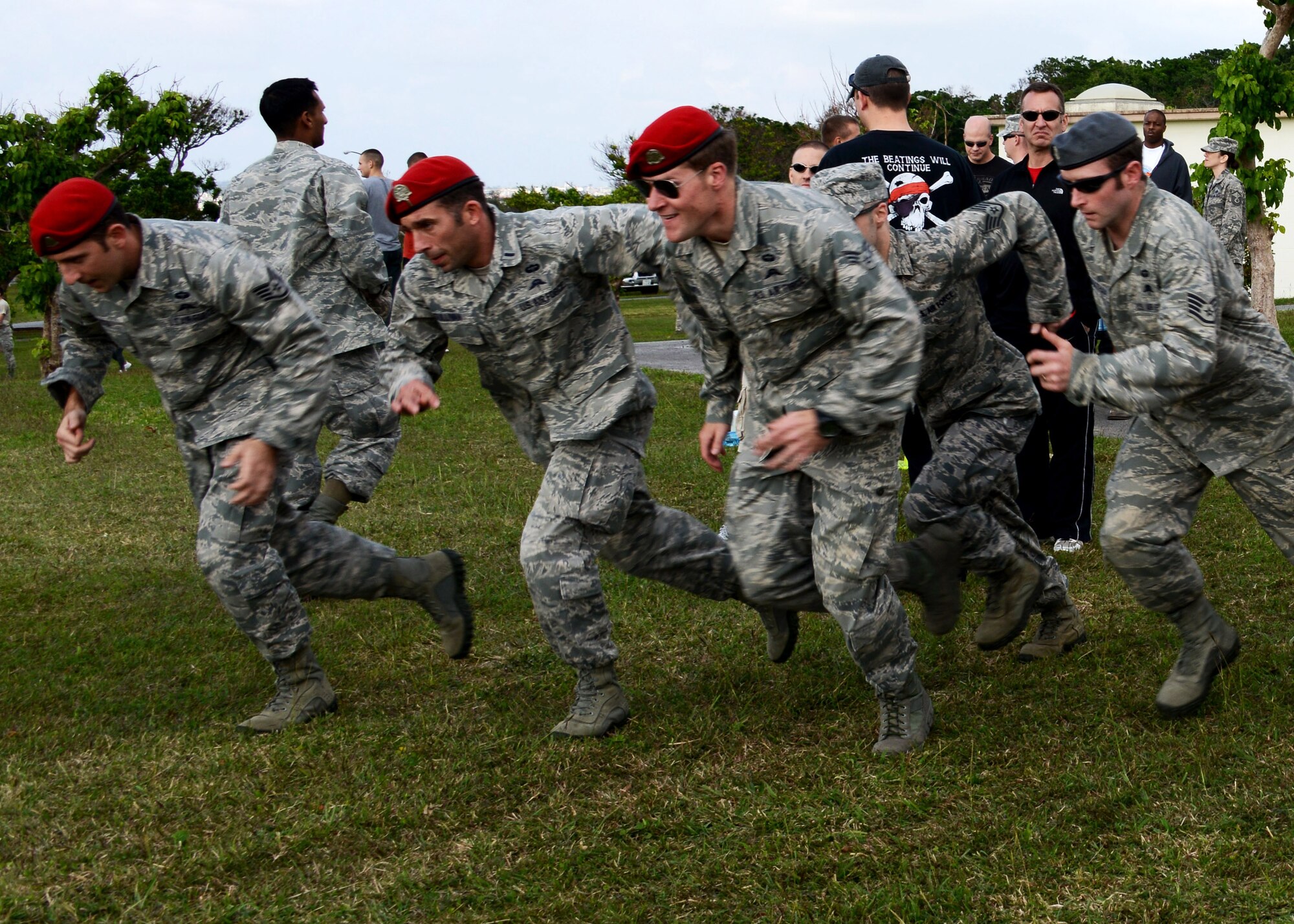 A team from the 320th Special Tactics Squadron tests their physical strength along with their mental strength during the 13 critical attributes challenge held during the 353rd Special Operations Group Wingman Day picnic here Dec. 17.  The challenge included stations where each team had to complete a task associate with Air Force Special Operations Command’s 13 critical attributes of success.  Each squadron was represented by two teams which included one person from each rank tier and a family member.  The 320th Special Tactics Squadron won the event.  The Wingman Day picnic was just one of many events held by the 353rd SOG to take time away from the day-to-day mission and bring together the entire group to include family members.  Earlier in the day, workcenters held small group discussions while the chaplain held a forum with family members.  (U.S. Air Force photo/Tech. Sgt. Kristine Dreyer)