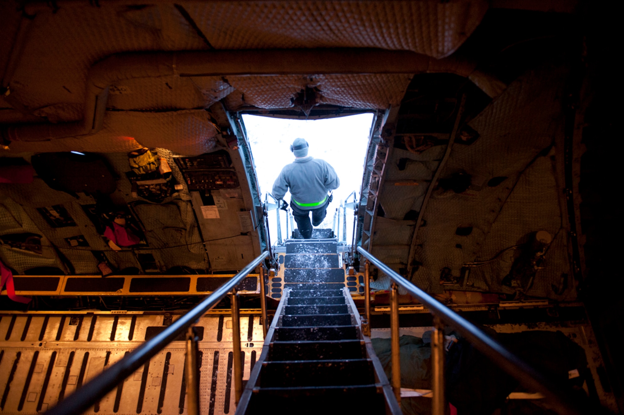 A member of the 732nd Aircraft Maintenance Squadron walks down multiple flights of stairs to exit an installation C-5A Galaxy during its stay on JBER Dec. 18. Aircraft maintainers work on more than 150 aircraft including C-17 Globemasters, KC-10 Extenders, L-100???s, DC-6s and more flying into JBER monthly. (U.S. Air Force photo/Staff Sgt. Robert Barnett)