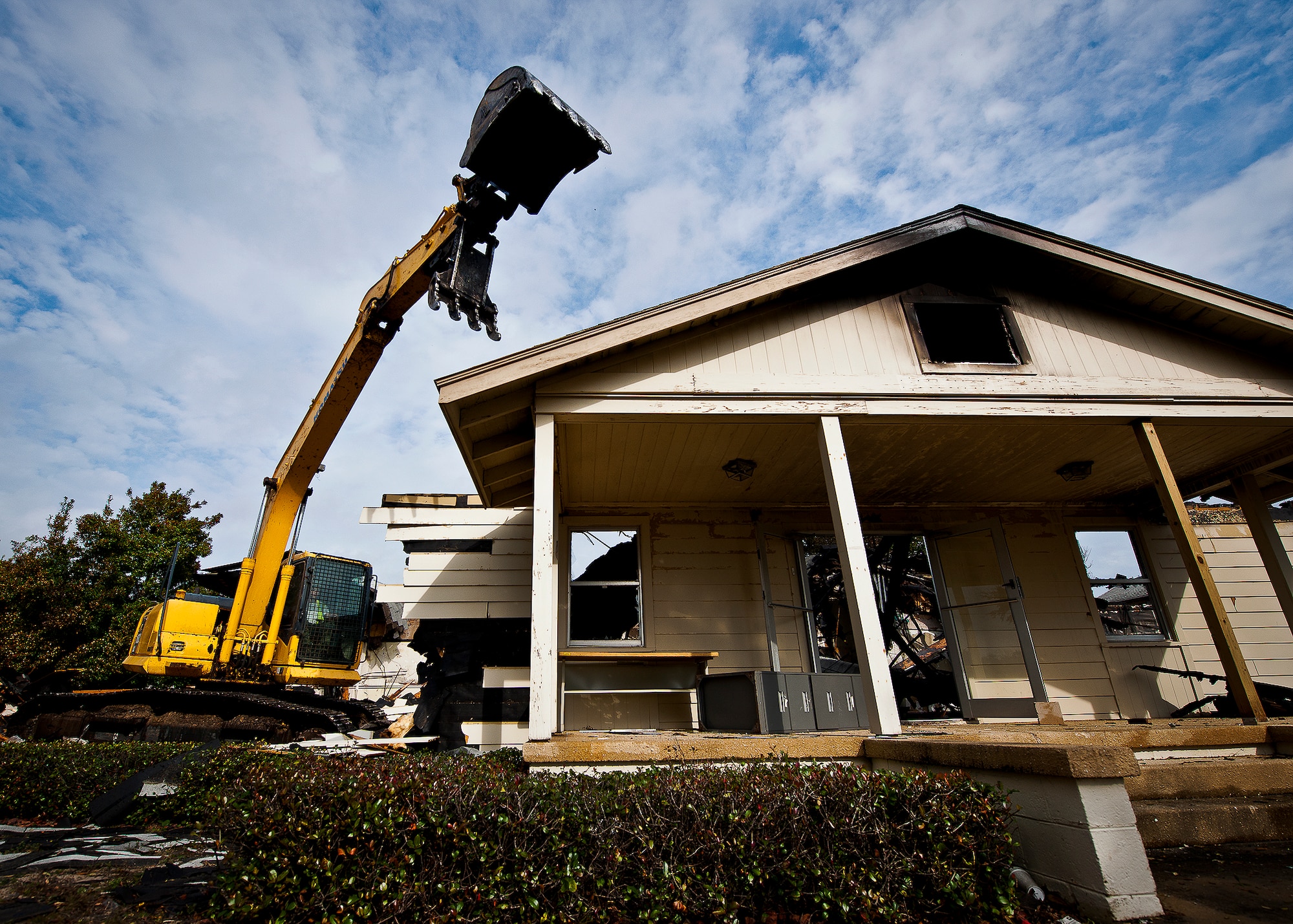 Jobe Everson, tears down Bldg. 666 with an excavator Dec. 20 at Eglin Air Force Base, Fla.  The old building was used by the 96th Civil Engineer Group for many years.  The entire demolition and clean up is supposed to take approximately two weeks depending on weather.  (U.S. Air Force photo/Samuel King Jr.)