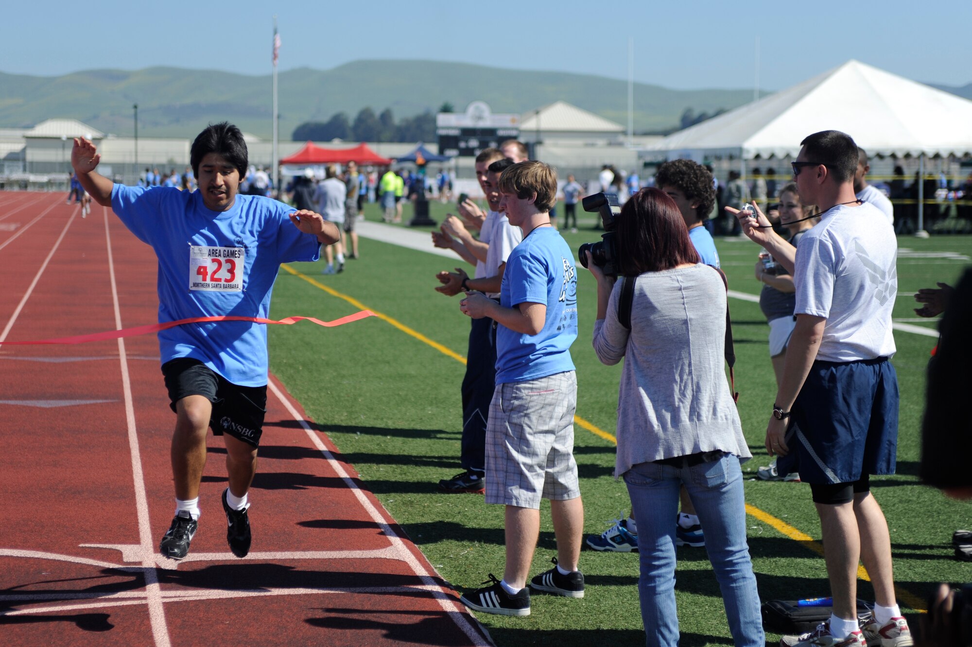 VANDENBERG AIR FORCE BASE, Calif. -- Patrick Del Real, a Special Olympics athlete, crosses the finish line during the Northern Santa Barbara County Special Olympics event at Pioneer Valley High School, Santa Maria Saturday, April 21, 2012. Team V members have volunteered with the Northern Santa Barbara County Special Olympics for more than 30 years. More than 145 base volunteers from 19 organizations participated in the event this year. (U.S. Air Force photo/Staff Sgt. Andrew Satran) 