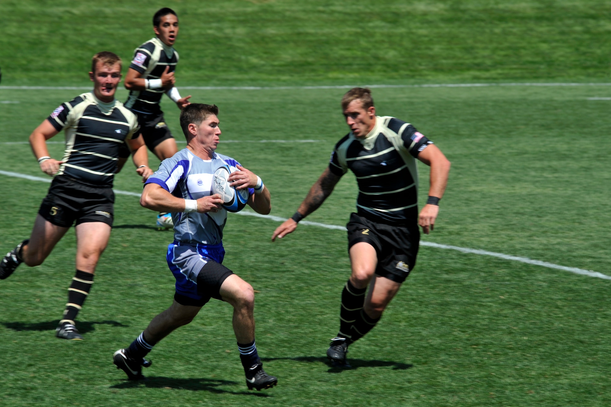 GLENDALE, Colo. -- A member of the Air Force rugby team gains possession of the ball after a scrum against Army rugby players Aug. 19, 2012. The Air Force team smashed their Army competetion in the Armed Forces Rugby Sevens Tournament. (U.S. Air Force photo by Riley Johnson) 
