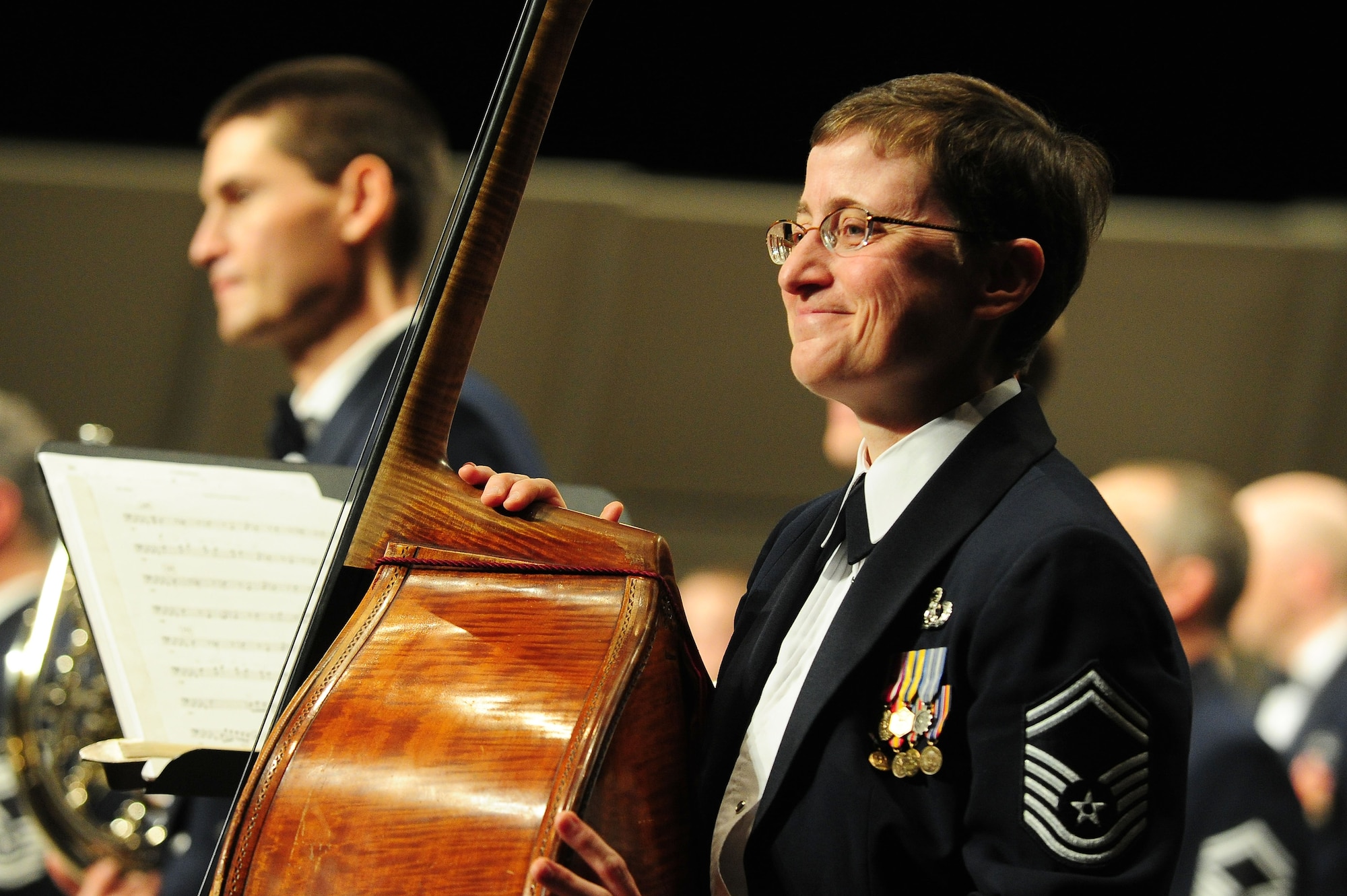 Senior Master Sgt. Chris Kosky, U.S. Air Force Band bassist, is humbled by the crowd's reaction following a perfomance at the 66th Annual Midwest Clinic, Dec. 19, in Chicago, Ill. "What a great way to end the night," said High School Band Director Christopher Poncin, who attended two of the band's three performances. "Thank you so much for everything you guys are doing; keep up the good work." (U.S. Air Force photo by Senior Airman Steele C. G. Britton)