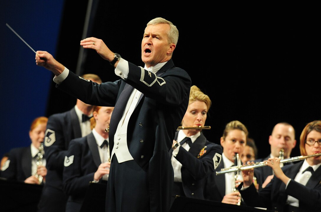 U.S. Air Force Band Commander Col. Larry Lang involves fellow musicians in the audience during the performance of the national anthem at the 66th Annual Midwest Clinic, Dec. 19, in Chicago, Ill. The U.S. Air Force Premier Concert Band performed three heart-pounding concerts for musicians, mentors and fans  gathered from across the world. (U.S. Air Force photo by Senior Airman Steele C. G. Britton)