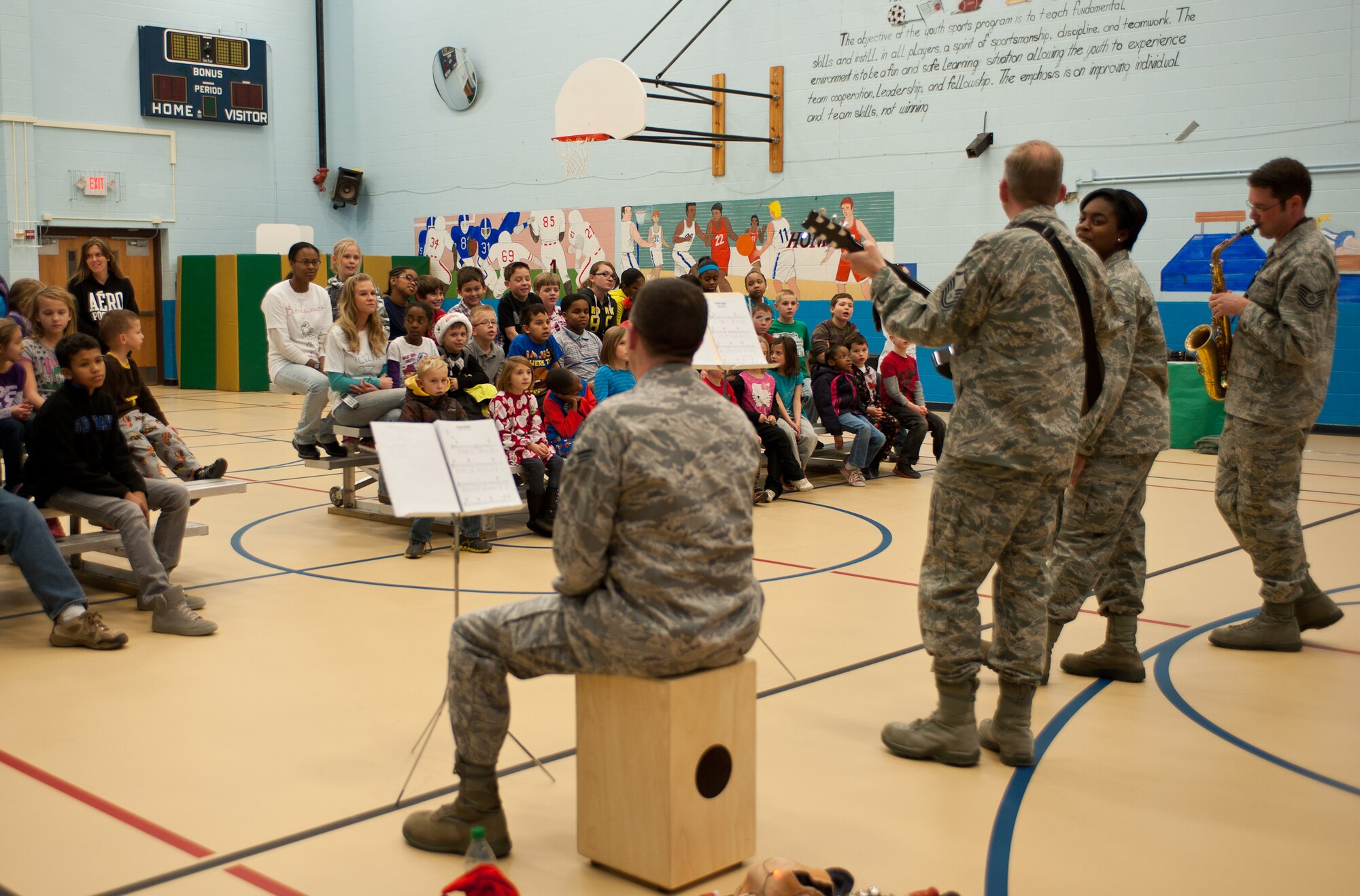 Members of the USAF Heartland of America Band bring holiday cheer to children at the 28th Force Support Squadron Youth Center during their tour at Ellsworth Air Force Base, S.D., Dec. 19, 2012. The group not only came to Ellsworth, but also visited Minot AFB, N.D., Grand Forks AFB, N.D., Cavalier Air Force Station, N.D., McConnell AFB, Kan., F.E. Warren AFB, Wyo. and Malmstrom AFB, Mont. during a tour to spread holiday cheer.(U.S. Air Force photo by Airman 1st Class Alystria Maurer/Released)