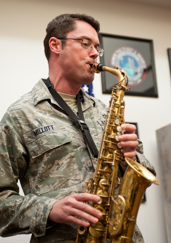 Tech. Sgt. Jason Millott, Heartland of America Band assistant NCO in charge alto saxophone player, performs a solo during “Silent Night” at Ellsworth Air Force, S.D., Dec. 18, 2012. The Heartland of America Band splits into small groups during the holidays to ensure every active-duty base in their region can enjoy their seasonal performances. (U.S. Air Force photo by Airman 1st Class Alystria Maurer/Released)