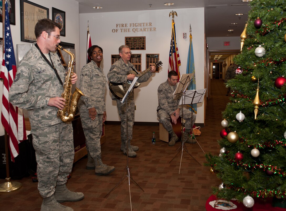 Members of the USAF Heartland of America Band bring holiday cheer to the 28th Civil Engineer Squadron Fire Department at Ellsworth Air Force Base, S.D., Dec. 18, 2012. Four band members visited several locations on base to entertain service members during the holiday season. (U.S. Air Force photo by Airman 1st Class Alystria Maurer/Released)