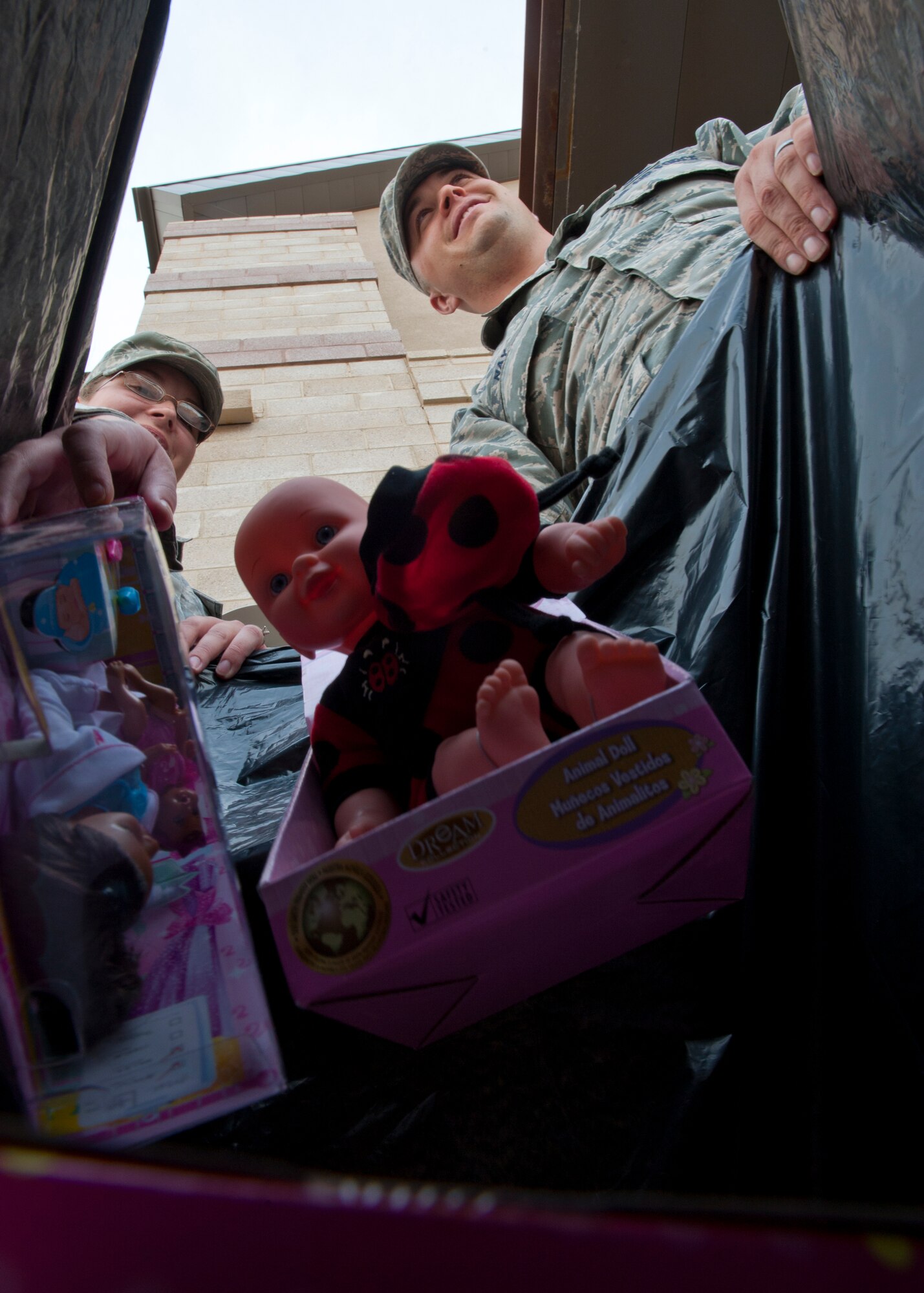 U.S. Air Force Staff Sgts. Samantha Hagan and Jackson Nay load donations from a Toys For Tots collection point at The Exchange at Holloman Air Force Base, N.M., Dec. 13. The two 49th Maintenance Operations Squadron maintenance training instructors initiated an expanded base-wide drive this year, with 26 collection points. The toys will be distributed to underprivileged community members at the Sgt. Willie Estrada Memorial Civic Center in Alamogordo, N.M., Dec. 22 from 10 a.m. to 3 p.m. (U.S. Air Force photo by Staff Sgt. Carolyn Herrick/released)