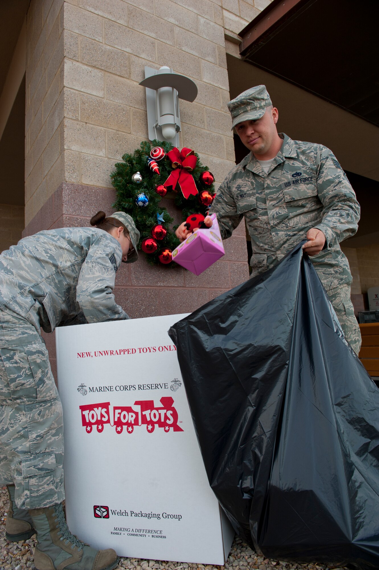 U.S. Air Force Staff Sgts. Samantha Hagan and Jackson Nay load donations from a Toys For Tots collection point at The Exchange at Holloman Air Force Base, N.M., Dec. 13. The toys will be distributed to underprivileged community members at the Sgt. Willie Estrada Memorial Civic Center in Alamogordo, N.M., Dec. 22 from 10 a.m. to 3 p.m. This is the largest Toys for Tots drive that Holloman AFB has ever held, with more than 300 toys collected. (U.S. Air Force photo by Staff Sgt. Carolyn Herrick/released)