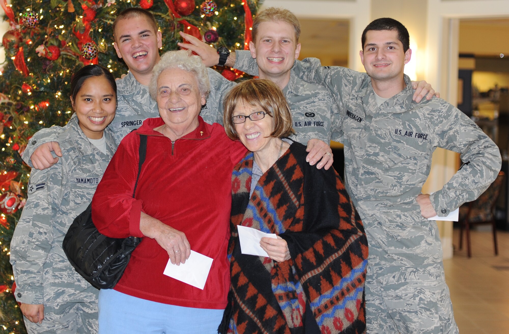 Members of Hurlburt Airman's Voice pose with residents during a card delivery at the Air Force Enlisted Village in Shalimar, Fla., Dec. 19, 2012. HAV members coordinated with Airmen Committed to Excellence at Kunsan Air Base, Republic of Korea, to deliver cards bearing well wishes from both bases on behalf of the widows. (U.S. Air Force photo / Senior Airman Allison LaPraim)