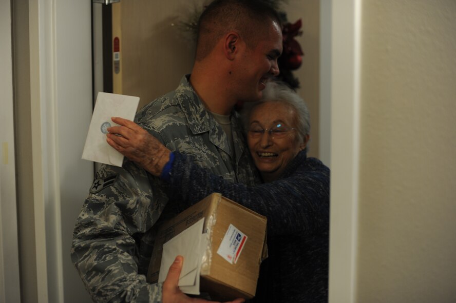 Airman 1st Class Theron Springer, a contracting specialist with 1st Special Operations Contracting Squadron and vice president of Hurlburt Airman's Voice, left, shares a hug with a resident of the Hawthorn House during a card delivery at the Air Force Enlisted Village in Shalimar, Fla., Dec. 19, 2012. HAV members coordinated with Airmen Committed to Excellence at Kunsan Air Base, Republic of Korea, to sign, seal and deliver the cards to the widows of the village. (U.S. Air Force photo / Senior Airman Joe McFadden)