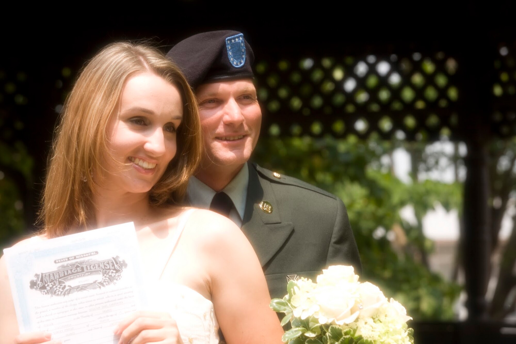 Senior Airman Erin Carpenter, left, smiles for a wedding photo with her husband. Both were married in ??? (Couresy photo)