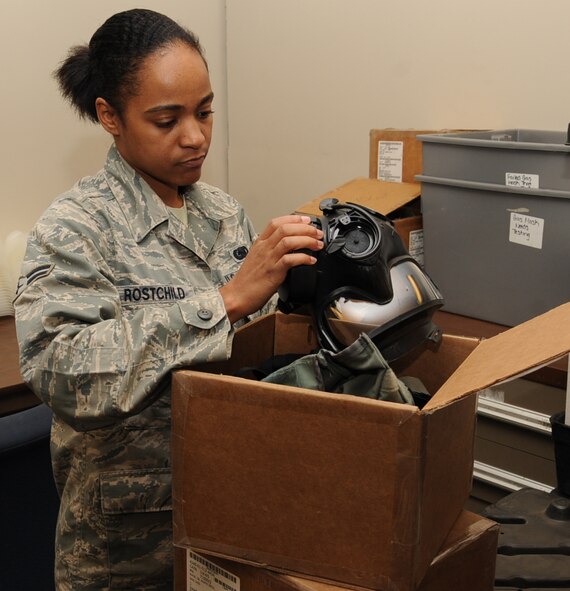 Airman 1st Class Burgundy Rostchild, 2nd Logistics Readiness Squadron material management journeyman, removes a canister from an M-50 gas mask before testing it on Barksdale Air Force Base, La., Dec. 20. The test is done to ensure the mask is serviceable. (U.S. Air Force photo/Senior Airman Sean Martin)