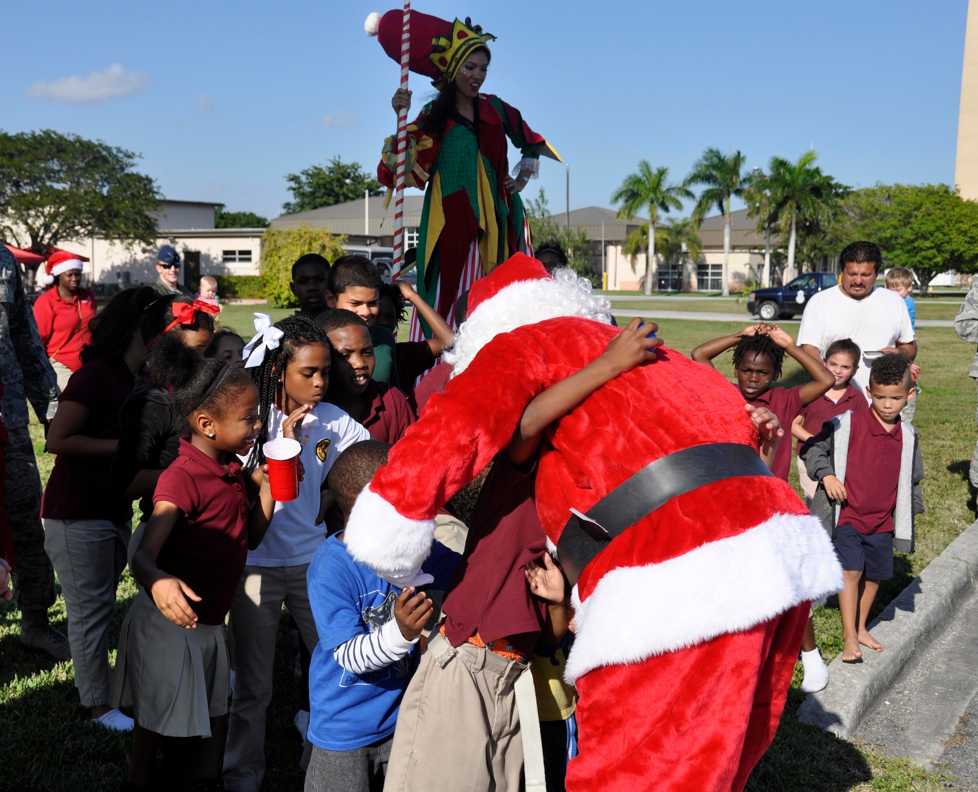 One of Santa Claus' giant elves greets children involved with Chapman partnership before Santa's arrival in an F-16 at Homestead Air Reserve Base, Fla., Dec. 19. Chapman Partnership, a local organization helping to combat homelessness, provides comprehensive services to empower homeless residents to become self-sufficient. Homestead ARB has also participated with Chapman Partnership on other events such as food drives. (U.S. Air Force photo/Senior Airman Jacob Jimenez)