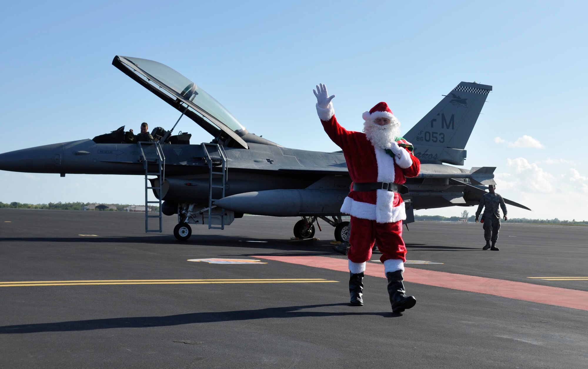 Santa Claus greets and embraces children involved with Chapman Partnership after arriving in an F-16 at Homestead Air Reserve Base, Fla., Dec. 19. Chapman Partnership, a local organization helping to combat homelessness, provides comprehensive services to empower homeless residents to become self-sufficient. Homestead ARB has also participated with Chapman Partnership on other events such as food drives. (U.S. Air Force photo/Senior Airman Jacob Jimenez)