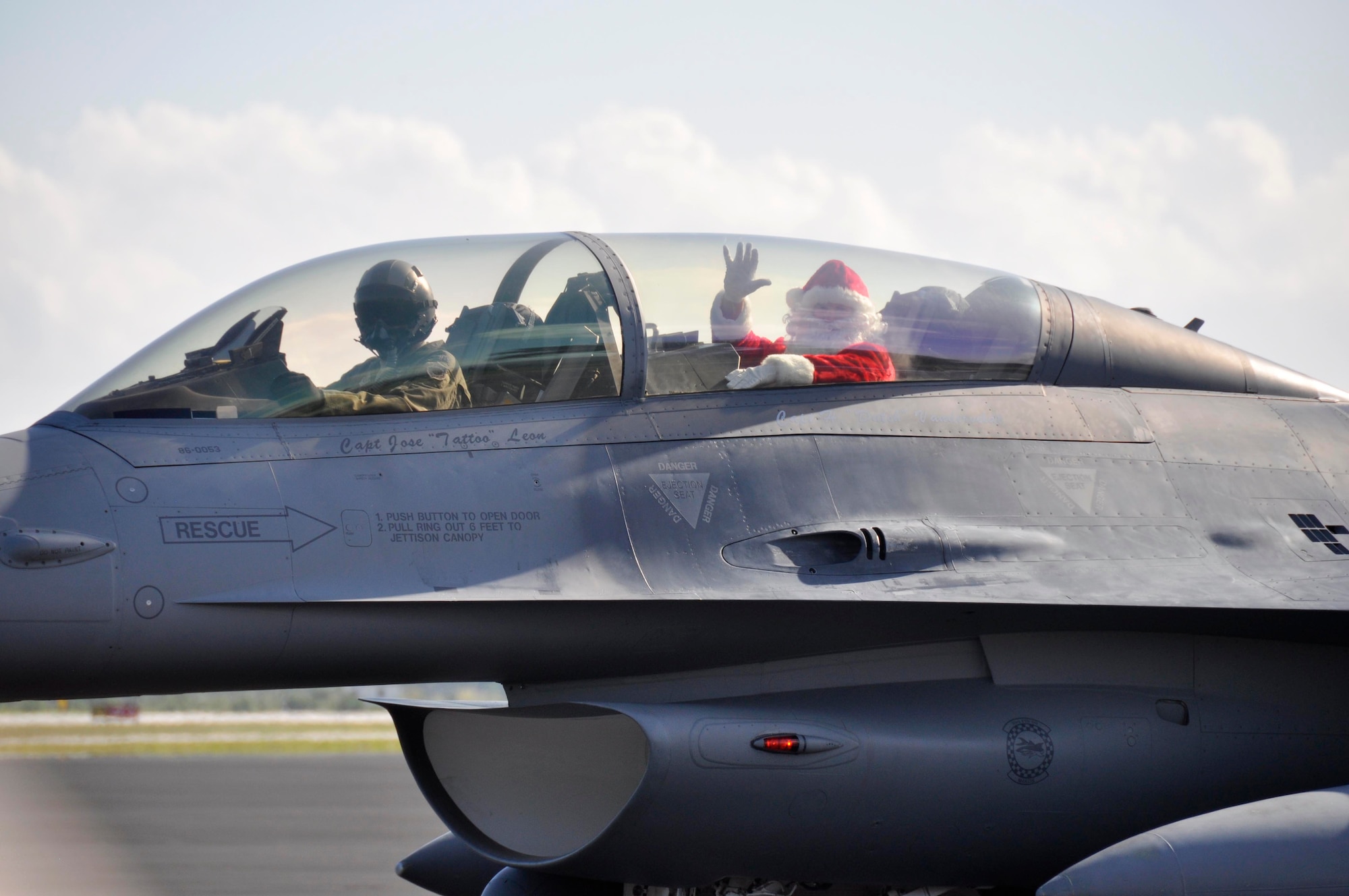 Santa Claus steps out of an F-16 to greet children involved with Chapman Partnership at Homestead Air Reserve Base, Fla., Dec. 19. Chapman Partnership, a local organization helping to combat homelessness, provides comprehensive services to empower homeless residents to become self-sufficient. Homestead ARB has also participated with Chapman Partnership on other events such as food drives. (U.S. Air Force photo/Senior Airman Jacob Jimenez)