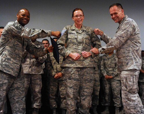 (On left) Chief Master Sgt. Les Bramlett, 15th Wing command chief, and Col. Johnny Roscoe, 15th WG commander, tack technical sergeant stripes onto the sleeves of Staff Sgt. Simona Patrick, 647th Force Support Squadron, during a step-promotion at the 15th WG commander's call at the base theater Dec. 18 at Joint Base Pearl Harbor-Hickam, Hawaii. Patrick was the only staff sergeant selected through the "Stripes for Exceptional Performers," or "STEP" program this year from a pool of nearly 900 other staff sergeants from the 15th Wing and 647th Air Base Group. (U.S. Air Force photo by Staff Sgt. Nathan Allen)
